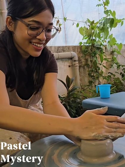 The pure joy of seeing the clay respond to your touch. This is a perfect shot of a guest fully immersed and smiling as she learns the art of wheel throwing in our studio.
