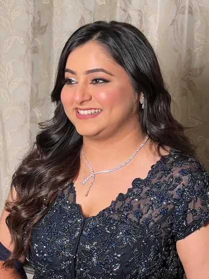 A beautiful smile from a happy client. Her makeup is designed to be radiant and joyful, with a touch of shimmer on the eyes to make them pop.