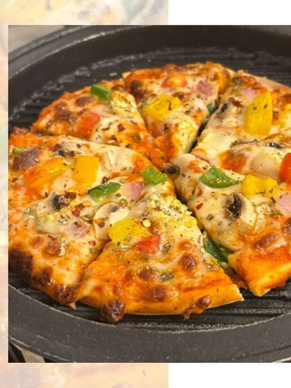 Who doesn't love pizza? A freshly baked pizza with colourful bell peppers, hot off the grill and ready to be served at a party.
