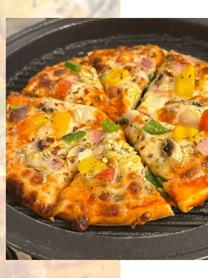A freshly grilled pizza with colorful bell peppers and mushrooms. We can include live pizza stations at events, providing a fun and interactive experience for guests.