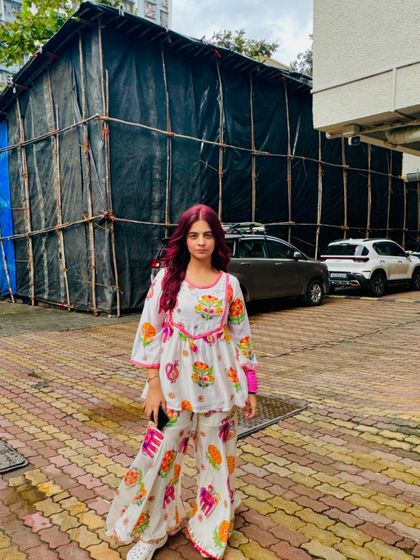 A cute and colorful ethnic co-ord set perfect for festive days. The peplum-style top and matching flared pants are both comfortable and stylish for a pear-shaped figure.