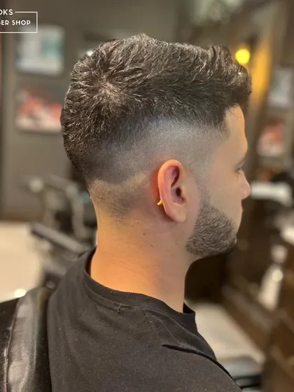 The back view of a high-quality fade is just as important as the front. Here, you can see the seamless blending and sharp outline that defines our work.