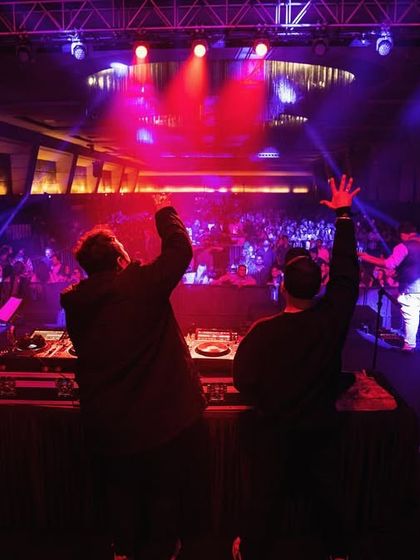 A shot from behind the console, showing DJ Yoschi and me hyping up the massive crowd. We work together to control the energy of the entire room.