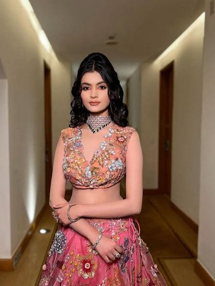 The full look, with a multi-colored pink and orange lehenga, perfect for a summer wedding.