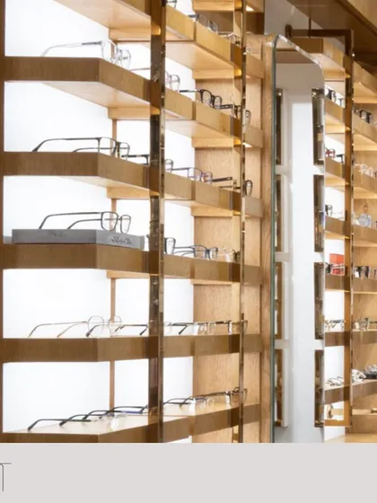 A detail of the wooden display shelves, showing the clean lines and warm lighting that create an elevated shopping experience.