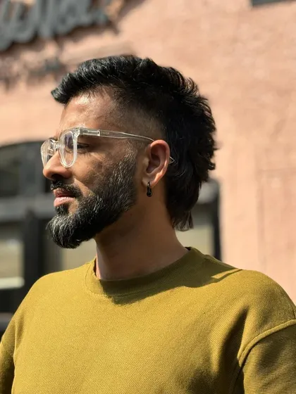 This angle highlights the clean fade on the sides of the mullet, which is key to making this retro style look contemporary.