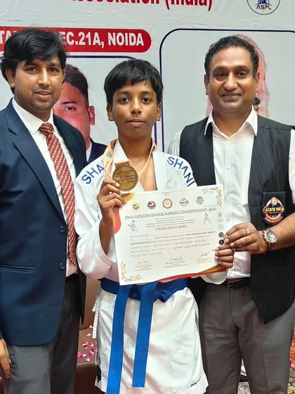 Another one of our young champions proudly displaying his medal and certificate of merit after a successful tournament.