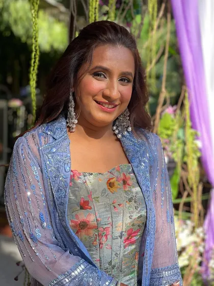 The client looking beautiful and happy, ready for her daytime wedding event with a fun and stylish hairstyle.