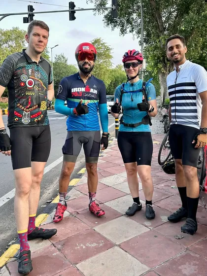 A group of four riders, including international members, posing together.