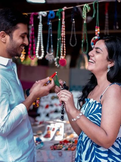 A playful moment of him helping her try on jewelry at a market stall. It’s these small, sweet interactions that make a pre-wedding shoot special.