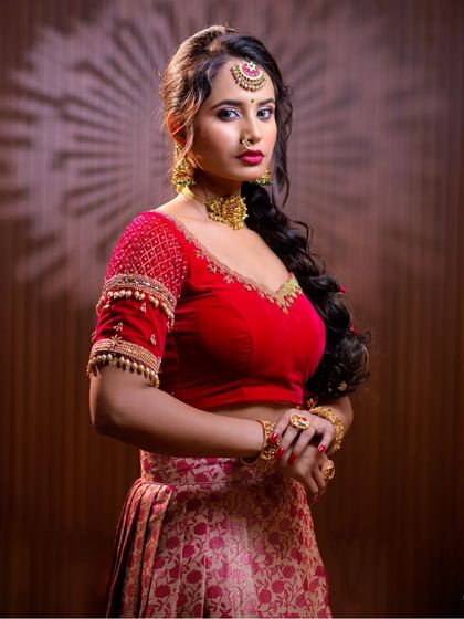 This series features a model in a red lehenga, wearing a simple but elegant gold-toned choker set. This is a great option for a pre-wedding puja or sangeet.
