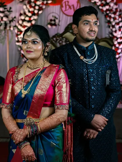 A classic stage portrait from a wedding reception. I ensure you get those essential, well-lit photos with your partner, capturing the grandeur of your evening attire and the decor.