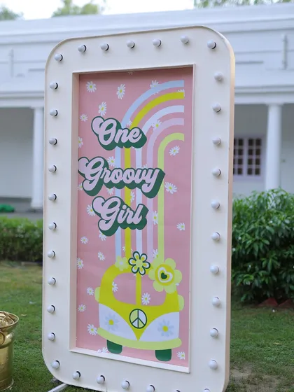 A light-up marquee sign with a "One Groovy Girl" retro design. This fun and stylish piece adds a unique touch to the sunshine and rainbows theme.