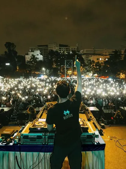 This is what it's all about. Standing before a massive crowd at the AatmTrisha festival at PES University, with a sea of lights shining back. I live for creating these moments of pure energy and connection on a grand scale.