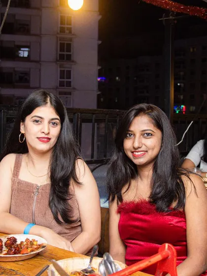 Enjoying dinner and drinks with a view of the city. Our rooftop seating offers a great spot for a more relaxed evening with friends.