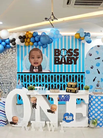 This polished Boss Baby theme is one of our most popular requests for first birthdays. The setup includes a custom backdrop, themed pedestals, and a large "ONE" marquee table, creating a perfect photo opportunity and central point for the celebration.