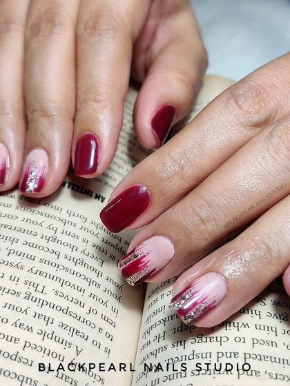 A simple yet elegant design featuring gel polish with abstract glitter brushstrokes. This is a great way to add a touch of artistic flair to a classic manicure.