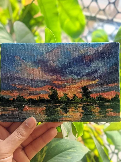 There is something so peaceful about a sunset. I used a mix of brushes and a palette knife to create the textured clouds and the reflection in the water. This miniature landscape painting is all about capturing that quiet end of day feeling.