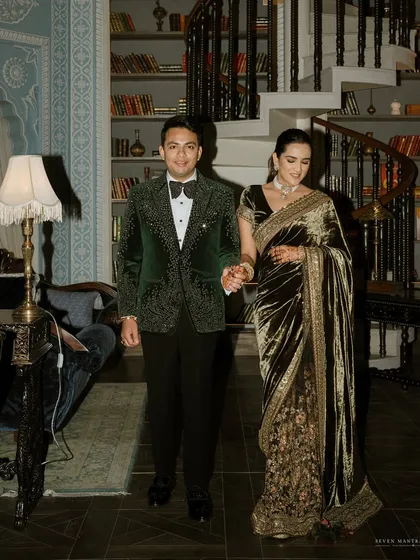 An entrance that feels both grand and intimate. I styled Khushi and Deepak for their reception in a rich, velvety Sabyasachi ensemble, set against the warm, literary backdrop of the library at Raffles Jaipur.
