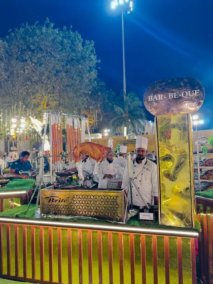 Another angle of the impressive barbecue setup, highlighting the "Bar-Be-Que" signage and the grand presentation.