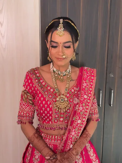 The complete bridal look, with her hair pulled back to showcase her stunning jewelry and makeup.