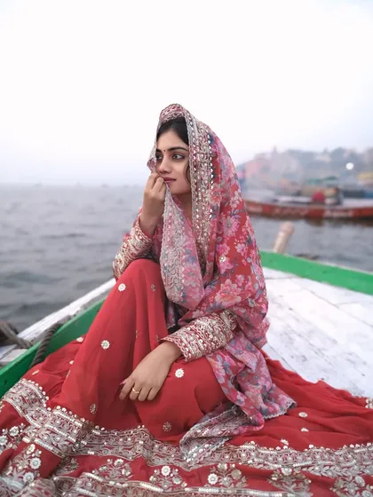 A moment of quiet contemplation on the sacred river. The soft light and traditional attire create a timeless and soulful portrait.