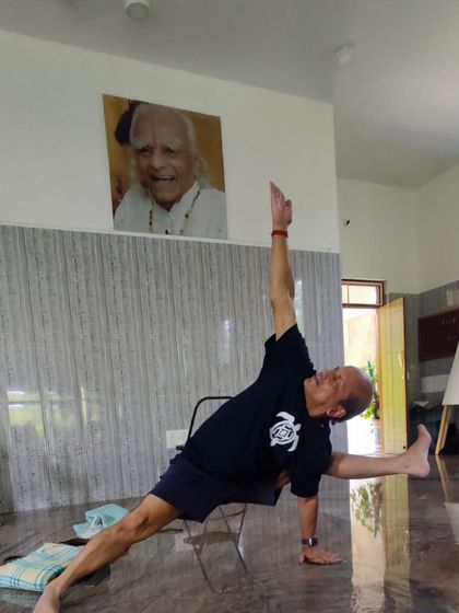 A variation of Vasisthasana (Side Plank) using a chair.
