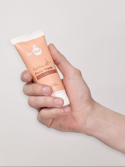 A straightforward shot of the In'lief face wash tube held in hand against a plain background. This "in-hand" shot helps customers judge the product's size and scale.
