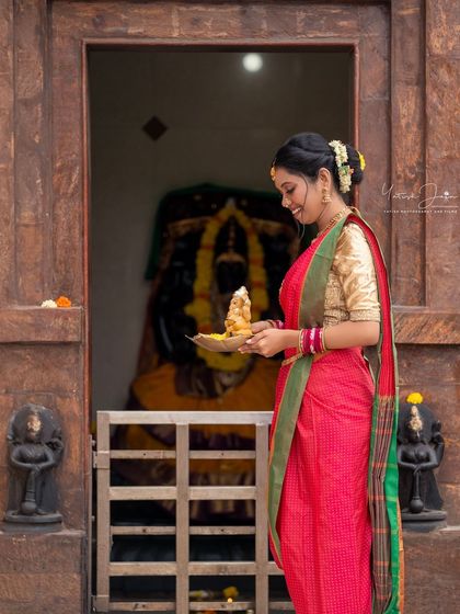A serene moment of worship. The makeup is kept elegant and respectful, with a soft glow that looks beautiful in the temple's natural light.