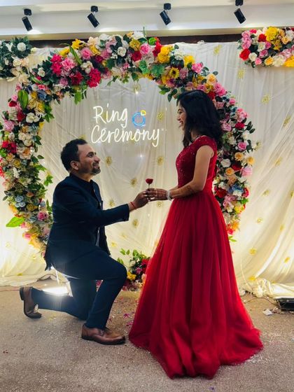 The perfect "yes" moment captured forever. This classic red ball gown is a popular rental for ring ceremonies and engagement parties, ensuring you look like a princess.