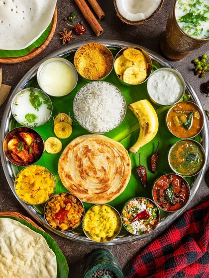 A grand South Indian thali, showcasing a wide variety of dishes on a single platter. This vibrant flatlay is a feast for the eyes.