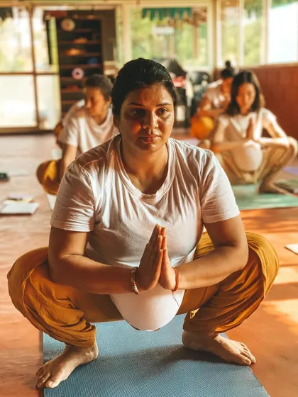 A student holds Malasana (Garland Pose), a fundamental squat that is excellent for hip mobility. We focus on mastering the foundations of asana practice.