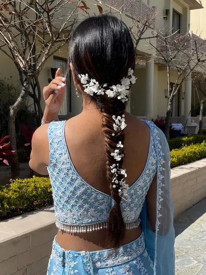 A full back view of the white floral fishtail braid, showing how the accessories cascade down the length of the hair for a truly ethereal effect.