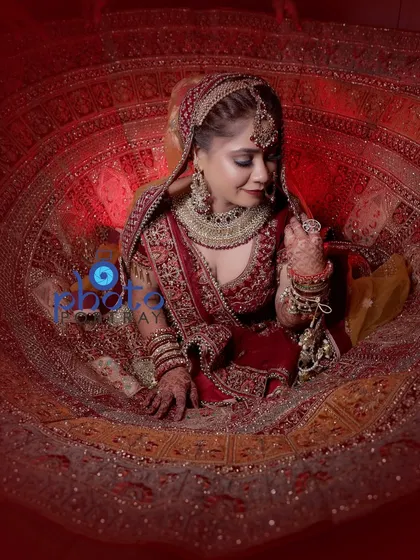 A classic bridal portrait is a must have. We create stunning shots that showcase the beauty and grandeur of the bridal lehenga, like this popular twirling pose, making the bride feel like she's in a fairytale.