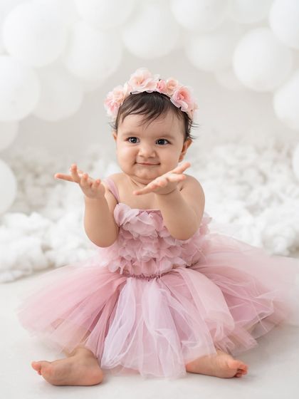 A beautiful portrait of a baby girl in a pink tutu for her first birthday shoot. She looks like a little princess.