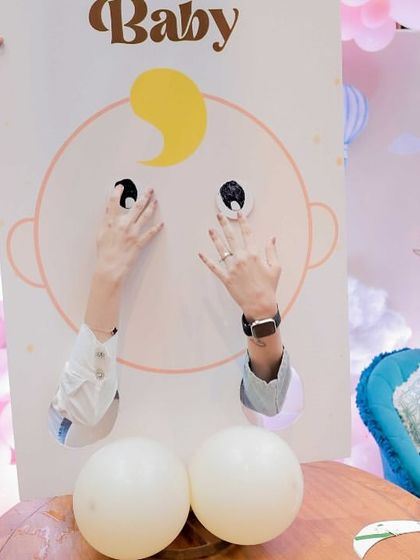 A guest having fun with one of our custom photo-op game boards. These props are always a hit for pictures.