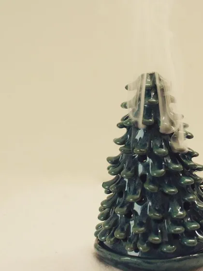 Here you can see the Coniferous tree being used as a backflow incense burner, with smoke gently cascading down its sides. It's a piece that engages multiple senses.