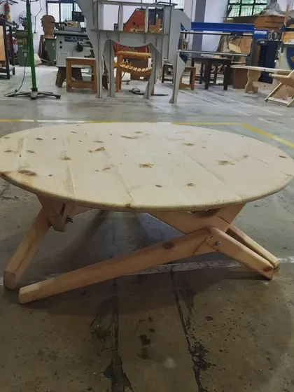 This collapsible round table demonstrates clever design and precise execution. Our students learn to create functional furniture that incorporates smart mechanisms, like this folding leg assembly for easy storage.