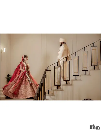 A stylish and modern wedding portrait of the couple on a staircase. The composition is clean and architectural, creating a unique and elegant image.