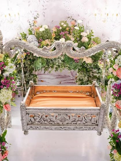 A close-up of the star of the show: the intricately carved silver cradle. We surrounded it with towers of fresh, colorful flowers, making it a worthy centerpiece for welcoming baby Inara.