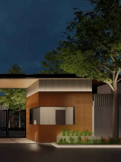 This simulation shows a lighting concept for a community entrance gate and guardhouse. The design provides necessary security and orientation while creating a welcoming ambiance through soft uplighting on trees and architectural elements.