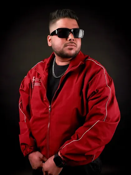 Another stylish pose from my 2025 shoot. The red jacket represents the high energy I'm known for.