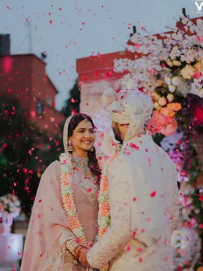 A magical moment under a shower of petals. Her makeup is perfectly set to last through every emotional and beautiful part of her wedding day.