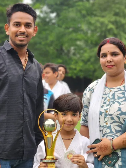 A young champion with his family and his awards. These moments make all the hardship worth it.
