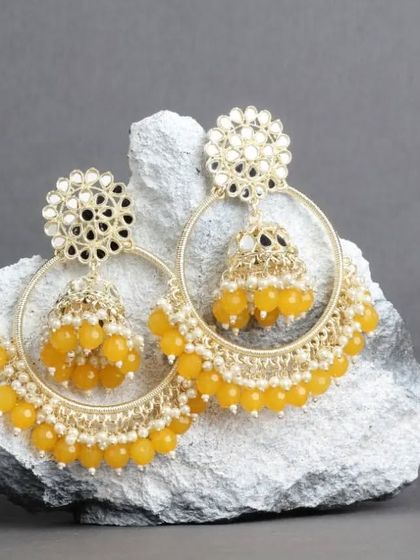 For a haldi ceremony or any sunny day, these yellow mirror work chandbali hoops are a perfect choice. They are bright, cheerful, and full of festive energy.