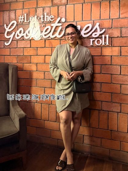 "Let the good times roll." A chic and effortless look in a draped olive green dress. This is a great example of a versatile piece that can be dressed up or down for various occasions.