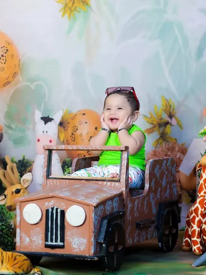 A moment of pure joy in the jungle. This baby is giggling with delight in his jeep, creating a candid and heartwarming photo.