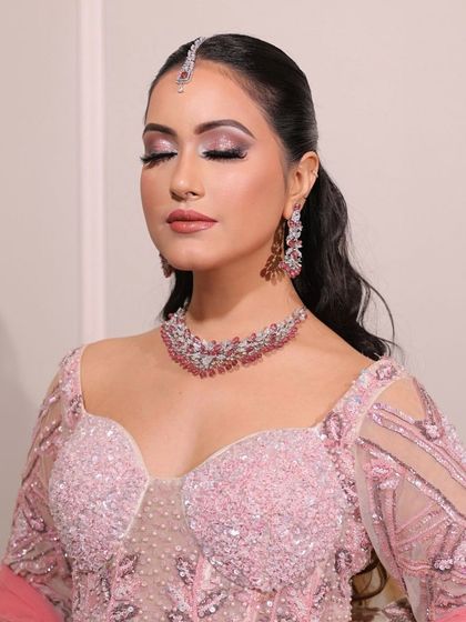 Soft pink hues for the perfect engagement glow. This close-up shows the delicate shimmer on the eyes and the flawless skin.