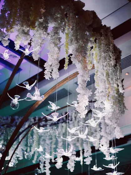 A detail shot of the suspended crystal birds and flowers. This showcases our focus on intricate, artistic details that add layers of beauty and wonder to our event designs.