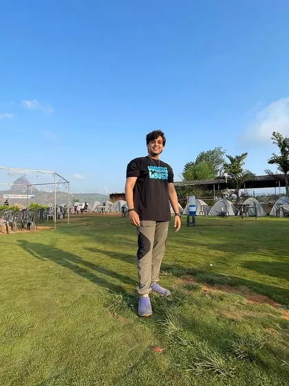 A full-length shot from the same camping location. It establishes the scene and shows a casual, comfortable style suitable for lifestyle content.